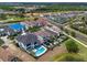 Beautiful real estate aerial of large luxury homes with pools adjacent to a serene lake at 960 Golden Bear Dr, Reunion, FL 34747