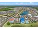 Aerial view of a luxurious residential neighborhood featuring beautifully designed homes and serene water features at 960 Golden Bear Dr, Reunion, FL 34747