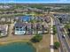 Luxury homes line a street and lake, offering pools and stunning views in a vibrant community at 960 Golden Bear Dr, Reunion, FL 34747