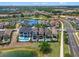 Picturesque aerial of a residential area with lakefront homes featuring private pools and lush green spaces at 960 Golden Bear Dr, Reunion, FL 34747