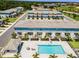 Aerial view showcasing townhouse exteriors, community pool, and manicured landscaping at 960 Golden Bear Dr, Reunion, FL 34747