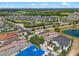 Expansive aerial view of a residential neighborhood featuring manicured lawns and houses with beautiful architectural designs at 960 Golden Bear Dr, Reunion, FL 34747