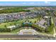 Overhead shot of the community amenities showcasing a playground, park, and beautifully landscaped streets at 960 Golden Bear Dr, Reunion, FL 34747