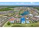 Aerial shot of a residential community showcasing luxurious homes located near a tranquil pond at 960 Golden Bear Dr, Reunion, FL 34747
