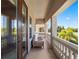 Covered balcony with comfortable seating, offering an inviting outdoor space at 960 Golden Bear Dr, Reunion, FL 34747