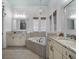 Bright bathroom with double vanity, soaking tub, and granite countertops at 960 Golden Bear Dr, Reunion, FL 34747