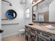 Steampunk-themed bathroom featuring custom vanity, mirror, and toilet at 960 Golden Bear Dr, Reunion, FL 34747