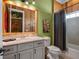 Rustic themed bathroom with wood accents, granite vanity, neutral cabinets, and shower/tub combo at 960 Golden Bear Dr, Reunion, FL 34747