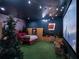 Whimsical bedroom with drive-in movie theme, complete with custom bed, string lights and a projector screen at 960 Golden Bear Dr, Reunion, FL 34747