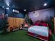 Fun themed bedroom features a truck bed, murals, artificial turf, and string lights at 960 Golden Bear Dr, Reunion, FL 34747