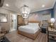 Unique bedroom features a woven bed frame, cloud wall mural, decorative lighting, and wood-look floors at 960 Golden Bear Dr, Reunion, FL 34747