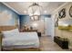 Bedroom featuring unique decor, a woven bed, cloud mural, and decorative lighting fixture at 960 Golden Bear Dr, Reunion, FL 34747