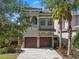 Charming two-story home featuring a paver driveway, two-car garage, and a balcony at 960 Golden Bear Dr, Reunion, FL 34747
