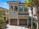 Charming two-story home featuring a paver driveway, two-car garage, and a balcony at 960 Golden Bear Dr, Reunion, FL 34747