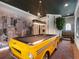 Custom game room with a pool table designed as a taxi cab and dark painted ceilings at 960 Golden Bear Dr, Reunion, FL 34747