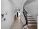 Spacious hallway with tile flooring, staircase, and neutral decor, providing a welcoming entrance at 960 Golden Bear Dr, Reunion, FL 34747