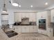 Well-equipped kitchen with stainless steel appliances and a spacious granite countertop island at 960 Golden Bear Dr, Reunion, FL 34747