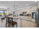 Bright kitchen with granite countertops, pendant lighting, and stainless steel appliances at 960 Golden Bear Dr, Reunion, FL 34747