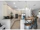 Modern kitchen with white cabinets, stainless steel appliances, and a granite-topped island at 960 Golden Bear Dr, Reunion, FL 34747