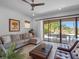 Comfortable living room featuring a cozy sectional sofa and sliding glass doors opening to the pool at 960 Golden Bear Dr, Reunion, FL 34747