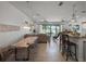 Bright, open floor plan combining living room, dining area, and kitchen with seamless access to outdoor pool at 960 Golden Bear Dr, Reunion, FL 34747