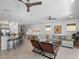 Spacious living area with tile flooring, stylish furniture, and open layout connecting kitchen and dining at 960 Golden Bear Dr, Reunion, FL 34747