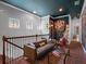 Open loft featuring a comfortable couch, and stylish décor with red brick flooring at 960 Golden Bear Dr, Reunion, FL 34747