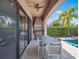 Covered outdoor patio with built-in grill, dining area, and view of the pool at 960 Golden Bear Dr, Reunion, FL 34747