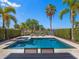 Beautiful backyard pool and spa with outdoor lounge chairs and lush landscaping around the pool at 960 Golden Bear Dr, Reunion, FL 34747