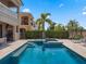 Beautiful backyard pool and spa with a lush green privacy hedge offering a relaxing retreat at 960 Golden Bear Dr, Reunion, FL 34747
