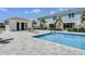 Inviting pool area featuring a well-maintained pool, elegant outdoor dining area, and a charming pool house at 960 Golden Bear Dr, Reunion, FL 34747
