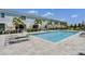 Inviting pool with sundeck areas surrounded by lush palm trees for relaxed outdoor living at 960 Golden Bear Dr, Reunion, FL 34747