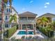 Home with an outdoor pool, manicured landscaping, and private balcony at 960 Golden Bear Dr, Reunion, FL 34747