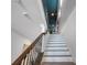 Elegant staircase with wrought iron railings and modern lighting leading to the upper level at 960 Golden Bear Dr, Reunion, FL 34747