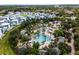 Community water park with pools, slides, palm trees, and blue and white architecture, perfect for Gathering fun at 960 Golden Bear Dr, Reunion, FL 34747