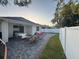 Large backyard featuring a covered patio, a hammock, and a well-manicured lawn, ideal for entertaining and outdoor activities at 9959 Cypress Vine Dr, Orlando, FL 32827