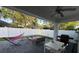 Covered backyard patio with outdoor seating, a grill, and a fenced yard providing the perfect space for relaxation at 9959 Cypress Vine Dr, Orlando, FL 32827