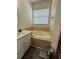 Bathroom featuring hardwood floors, a bathtub, a single vanity, and lots of natural light at 9959 Cypress Vine Dr, Orlando, FL 32827