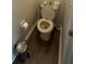 Small bathroom with hardwood floors, toilet and roll paper fixture at 9959 Cypress Vine Dr, Orlando, FL 32827