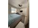 Bedroom offers a comfortable recliner, natural light, and sleek hardwood floors at 9959 Cypress Vine Dr, Orlando, FL 32827
