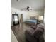 Spacious bedroom features hardwood floors, a plush recliner, and ample natural light at 9959 Cypress Vine Dr, Orlando, FL 32827