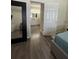 Bedroom featuring hardwood floors and a doorway leading to the bathroom at 9959 Cypress Vine Dr, Orlando, FL 32827