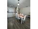Well-lit dining area adjacent to the kitchen, featuring seating for six and modern décor, ideal for entertaining at 9959 Cypress Vine Dr, Orlando, FL 32827
