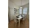 Bright dining area with a white table and chairs, complemented by built-in shelving and natural light at 9959 Cypress Vine Dr, Orlando, FL 32827