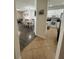 Inviting home entryway leading to the dining and kitchen areas with neutral tones and tile flooring at 9959 Cypress Vine Dr, Orlando, FL 32827
