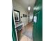 Inviting foyer with a green door, console table, mirror, and neutral flooring at 9959 Cypress Vine Dr, Orlando, FL 32827
