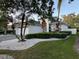 A single-story home with beautiful landscaping, featuring a paved driveway and a well-maintained lawn at 9959 Cypress Vine Dr, Orlando, FL 32827