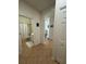 Hallway with ceramic flooring leading to a bathroom, linen closet and other rooms in this inviting home at 9959 Cypress Vine Dr, Orlando, FL 32827