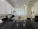 Bright kitchen featuring white cabinets, granite countertops, stainless steel appliances, and an adjacent dining area at 9959 Cypress Vine Dr, Orlando, FL 32827