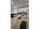 Clean kitchen with white cabinets, black countertops, and tile flooring at 9959 Cypress Vine Dr, Orlando, FL 32827